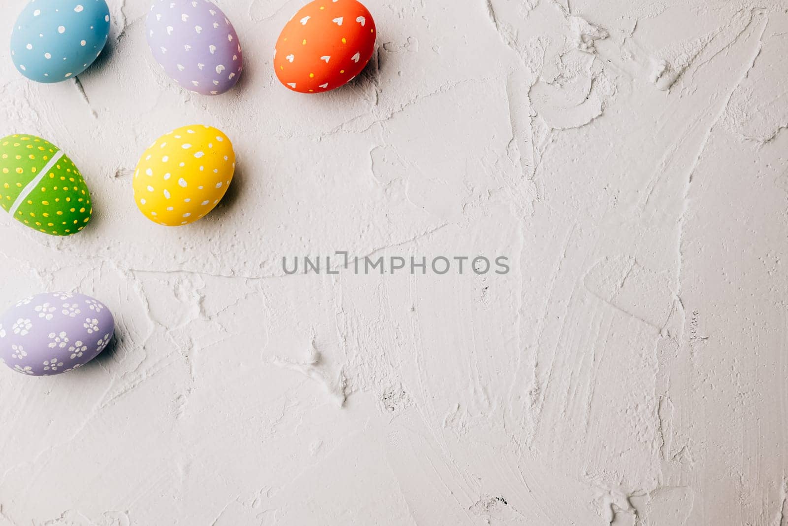 Easter Day Concept. Top view holiday banner background web design white colorful easter eggs painted on white cement background with empty copy space, celebration greeting card, overhead, template