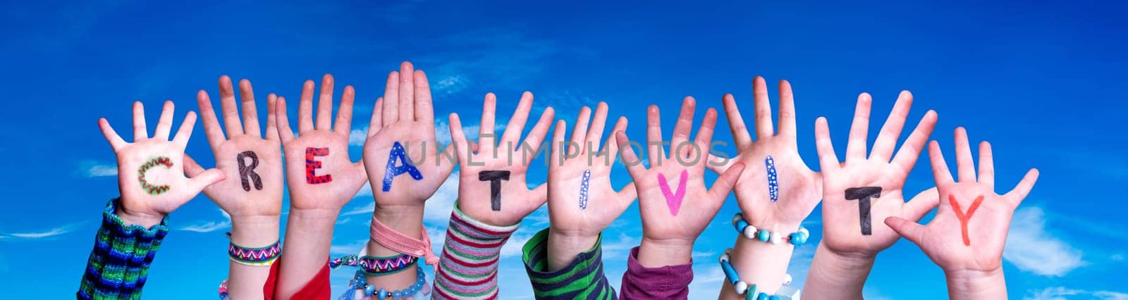Children Hands Building Colorful English Word Creativity. Blue Sky As Background