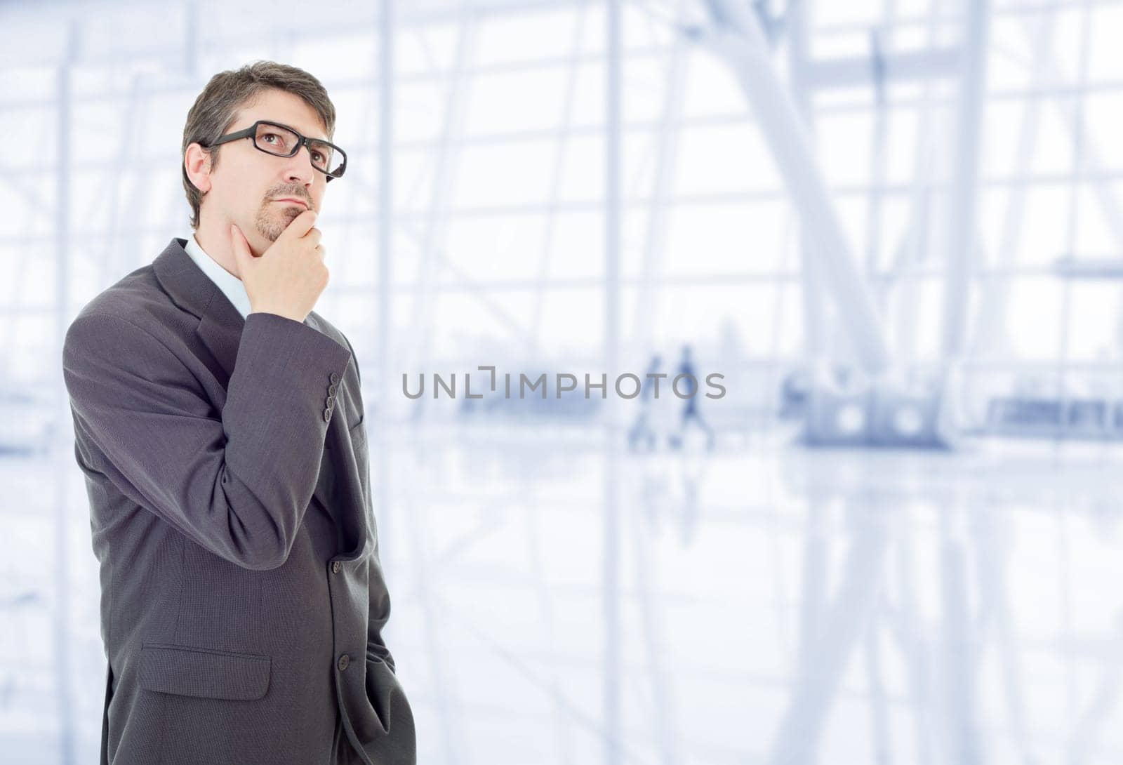 young business man thinking, at the office