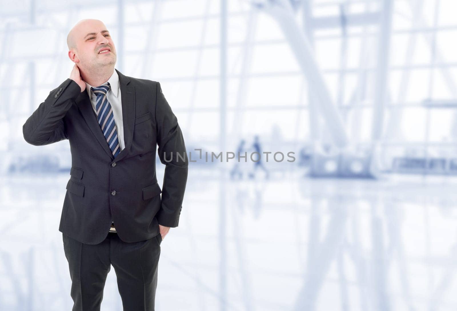 Young businessman with strong back pain, at the office