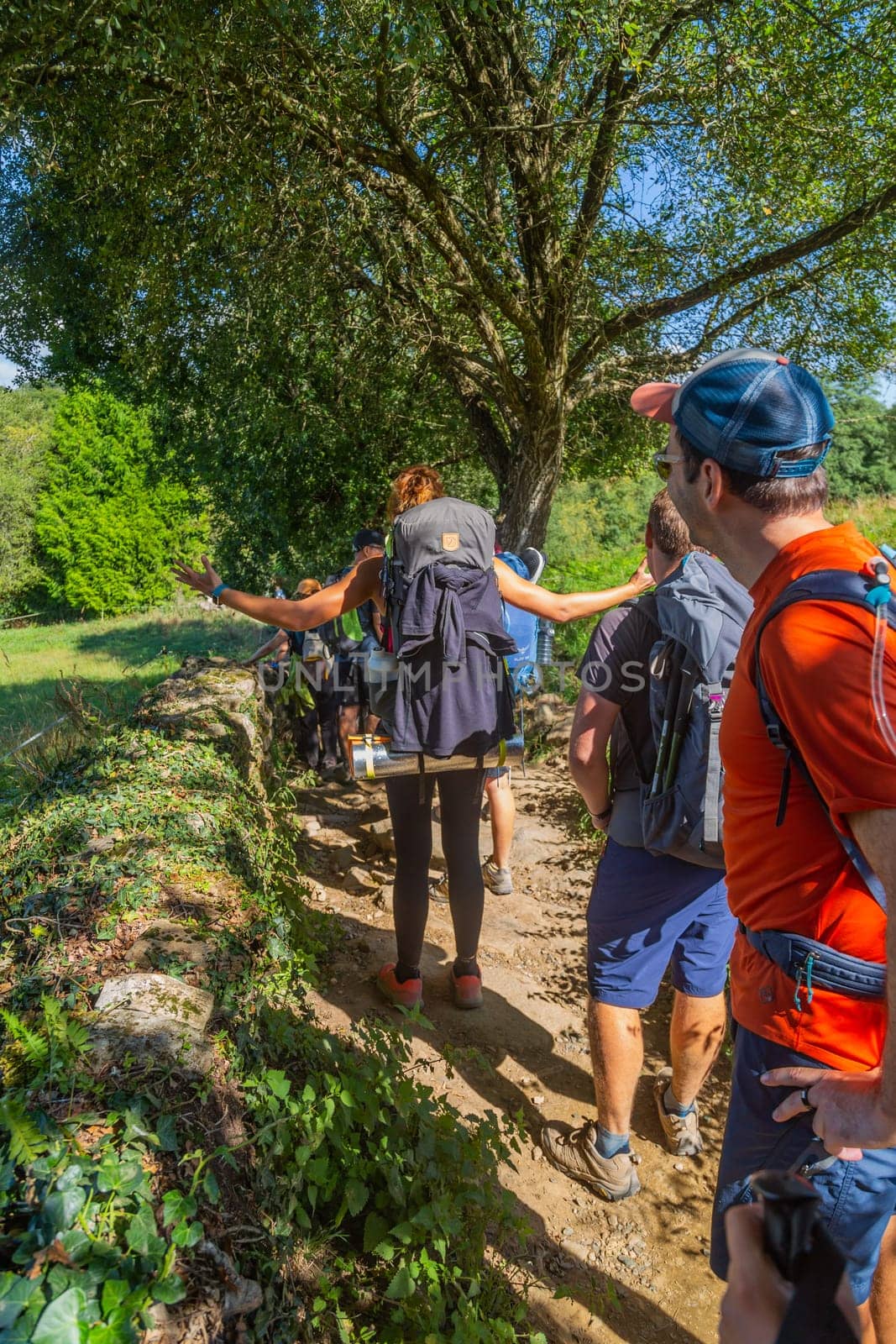 Navarre, Spain, 26 August, 2022: Pilgrims walk along the Camino De Santiago, the Way of St. James pilgrimage route, Navarra, Spain.