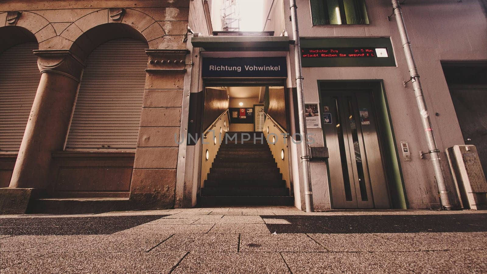 Low angle shot of a hidden entrance to a train station between two houses in Wuppertal, Germany