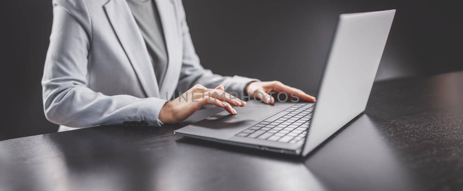 Woman with her laptop in the office and working. Concept of the workplace and business.