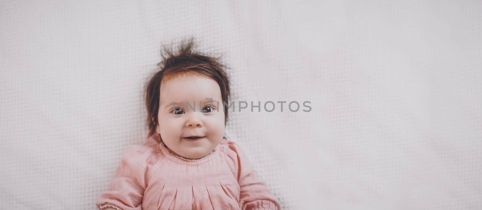 Cute little baby lying on the white blanket. Concept of childhood and new life.