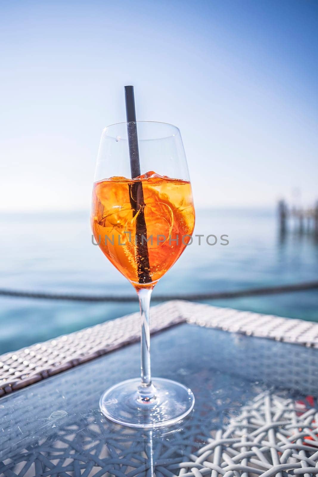 A luxurious bar setting on the Riviera, featuring exquisite glassware and a refreshing drink on a sleek bar table.