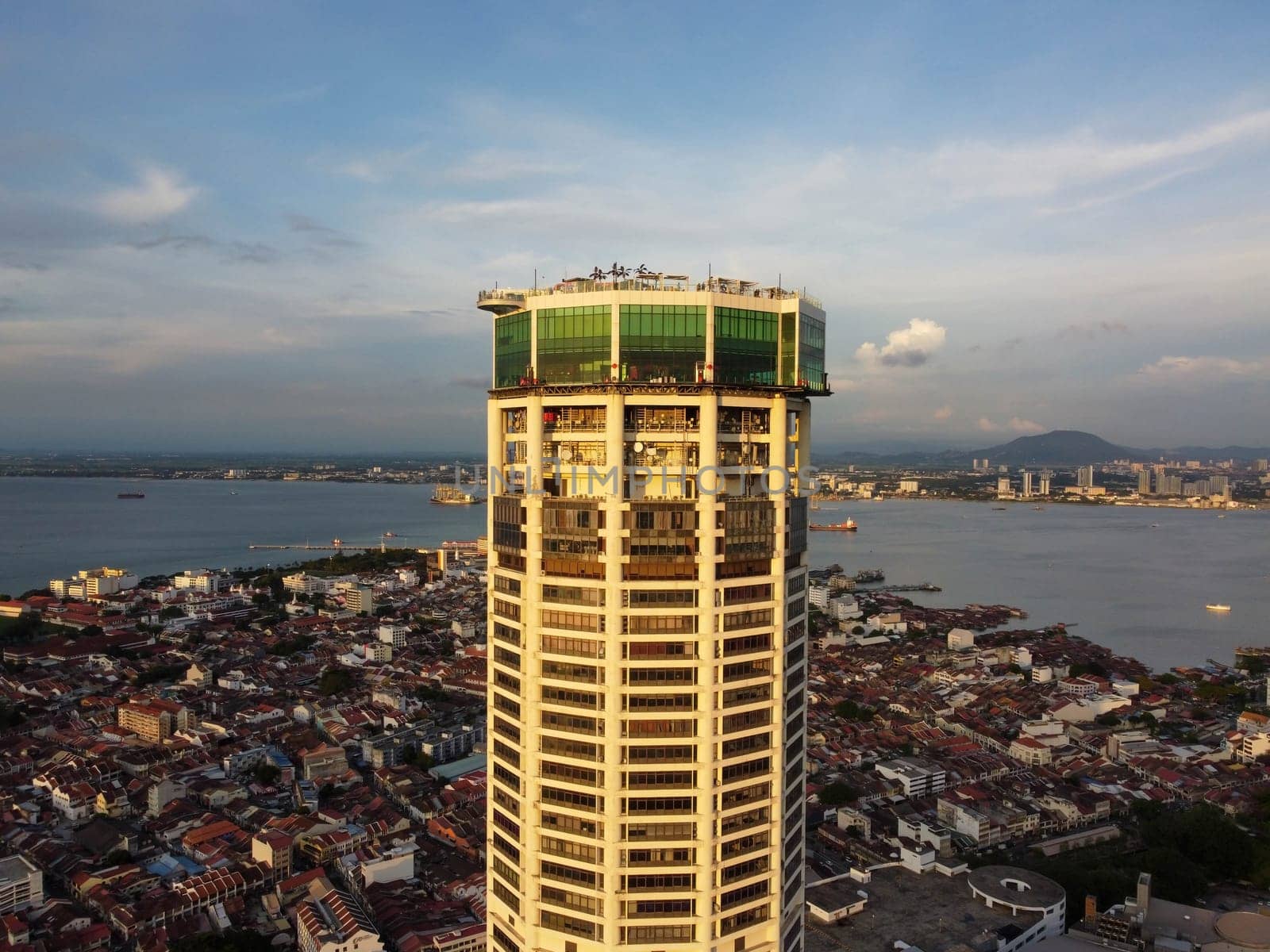 George Town, Penang, Malaysia - Jun 07 2022: Aerial view sun light evening at Komtar building and heritage George Town building at back