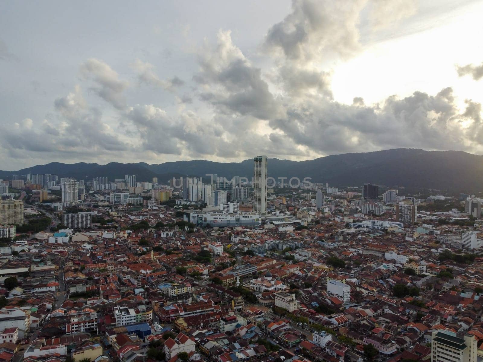 George Town, Penang, Malaysia - May 27 2022: Aerial view Komtar building and heritage old building in sunset cloud