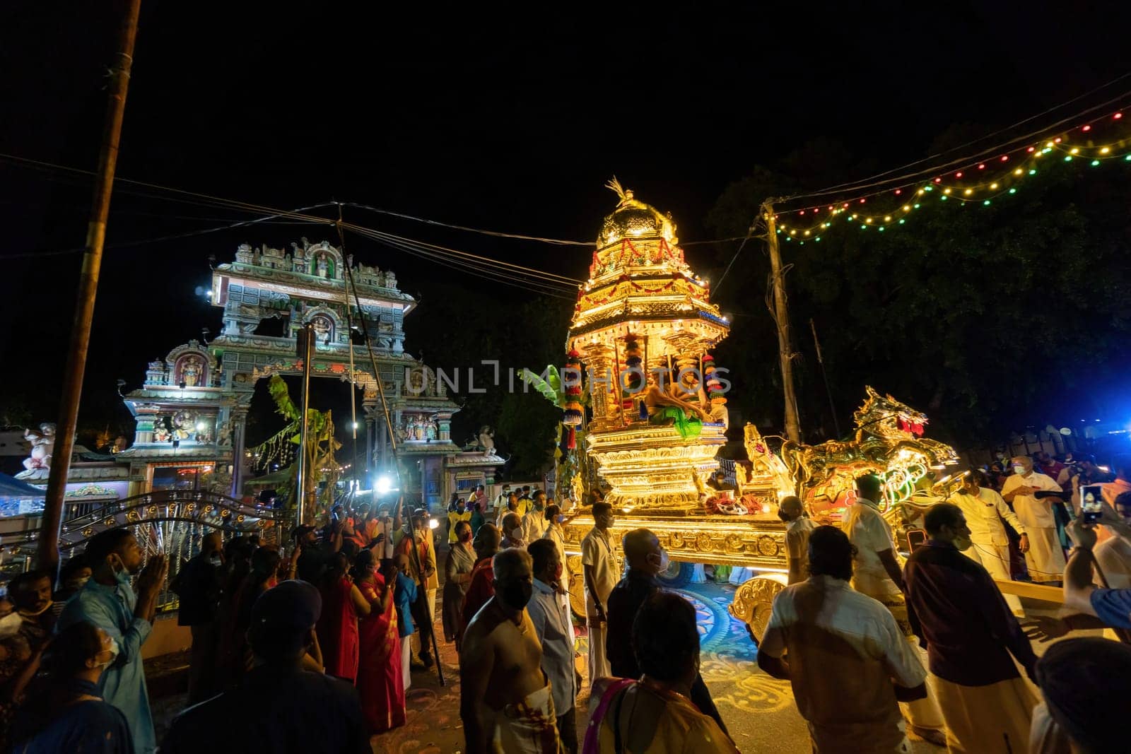 George Town, Penang, Malaysia - Jan 19 2022: Golden chariot with led light move cross the archway