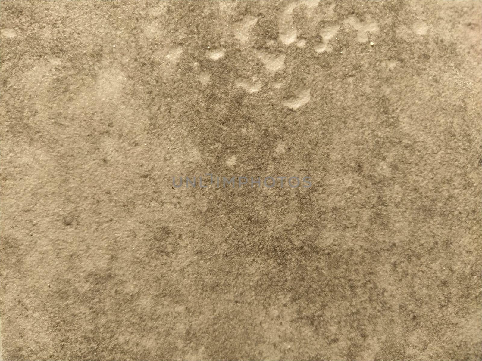 The textured surface of a concrete wall, marble or light stone with dark spots. Abstract background. Creative background light gray with red and brown pieces of moss, dirt and dust.