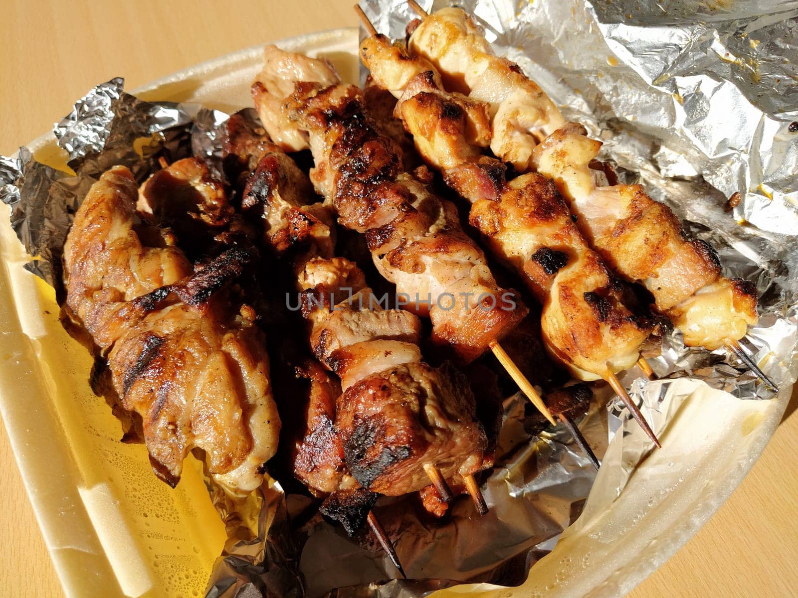 Home delivery food. Grilled chicken, pork skewers on sticks. Food from the restaurant. Dish in disposable plastic packaging. Beef patties, chevapy. Food delivery during self-isolation.