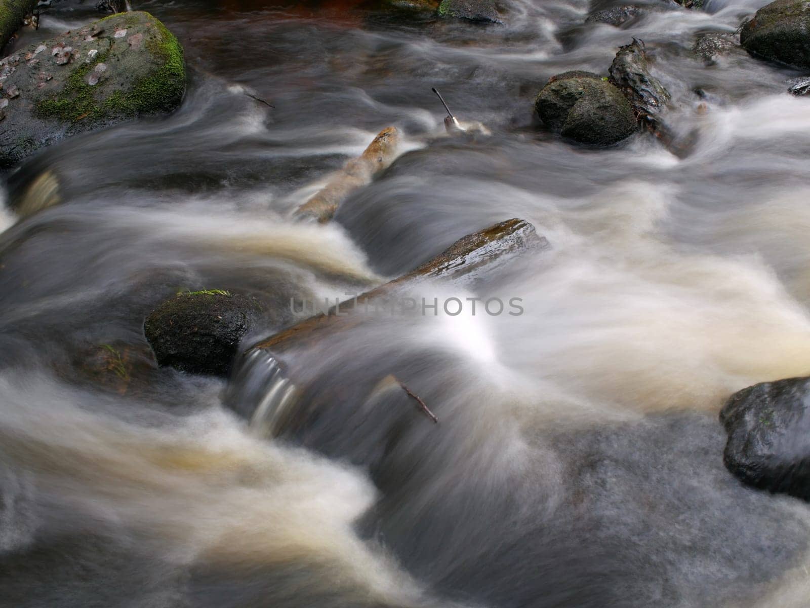 rocky river, fast flow of water long exposure