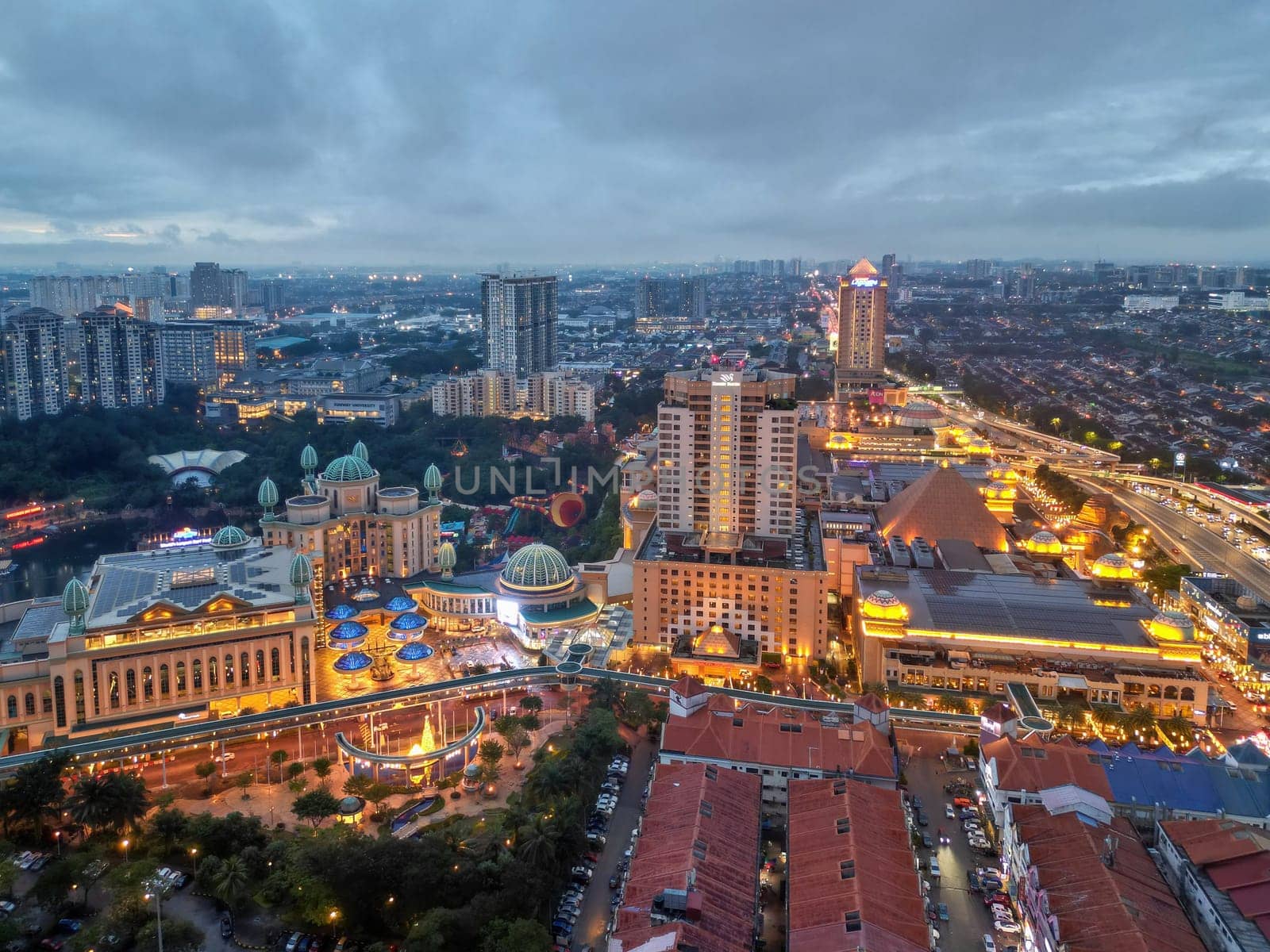 Sunway, Selangor, Malaysia - Nov 10 2022: Aerial view Sunway Resort in gold color and surround residential housing in blue hour