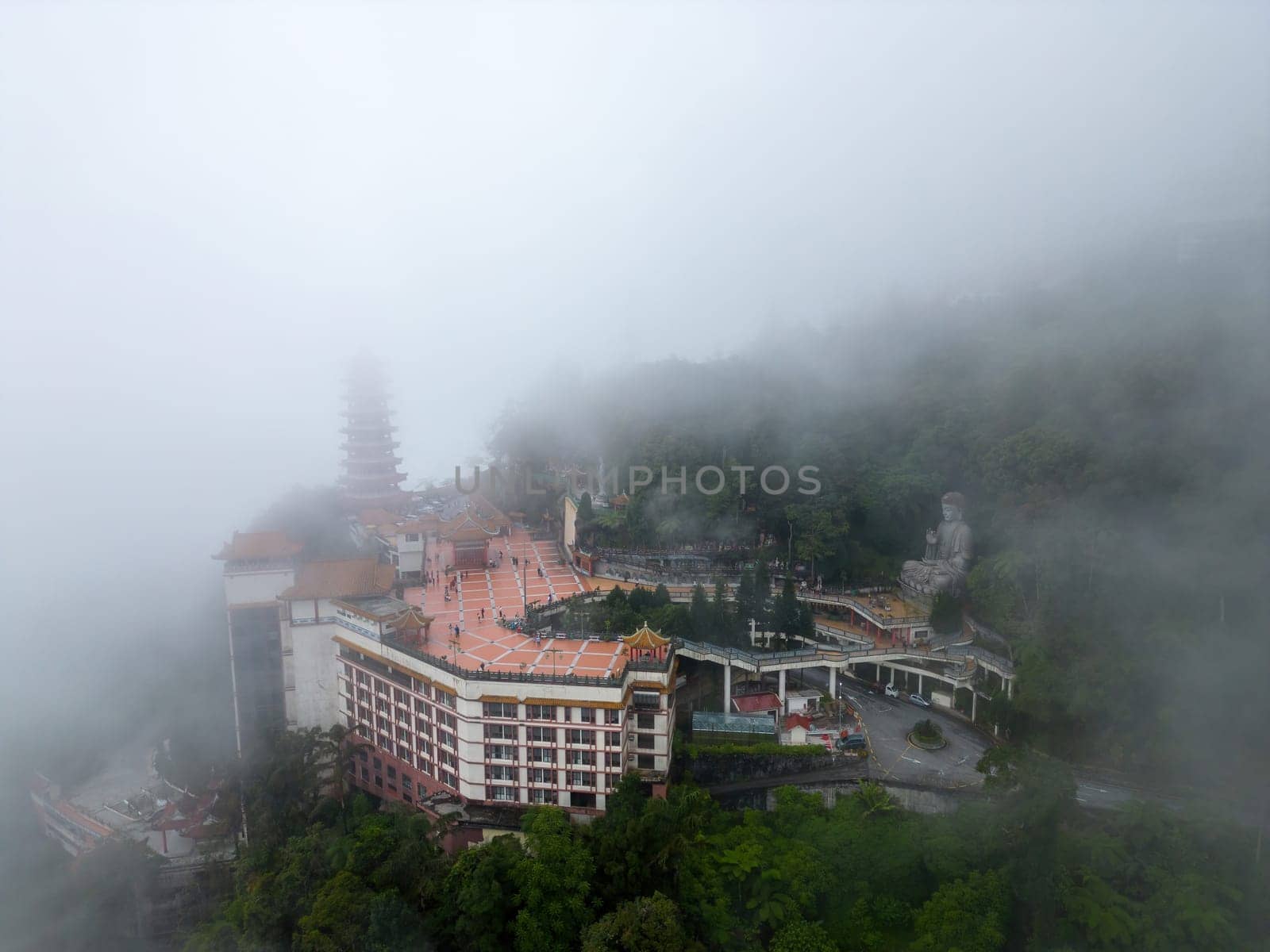 Genting, Pahang, Malaysia - Dec 04 2022: A mystical and enchanting view of the Chin Swee Caves Temple enveloped in a misty veil on a cloudy day
