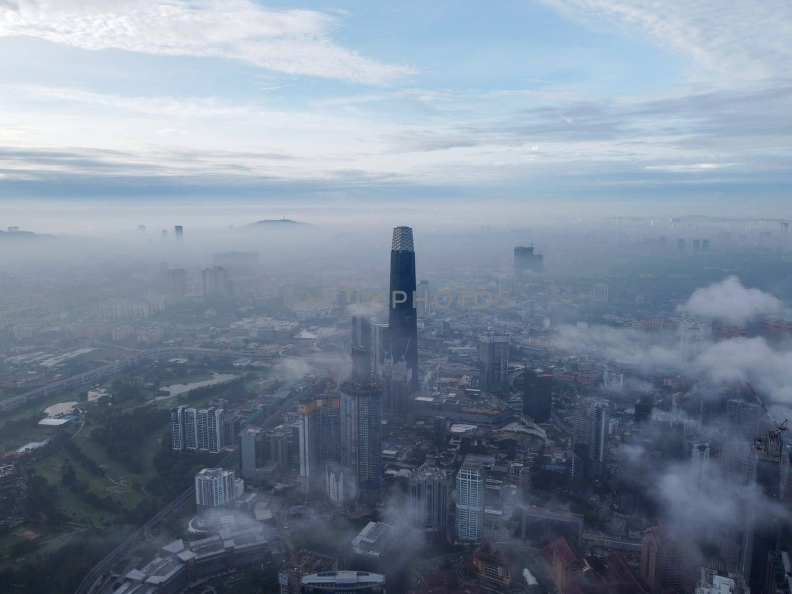 Bukit Bintang, Kuala Lumpur, Malaysia - Nov 13 2022: The Exchange 106 building looks majestic from an aerial view during the morning low cloud hours.