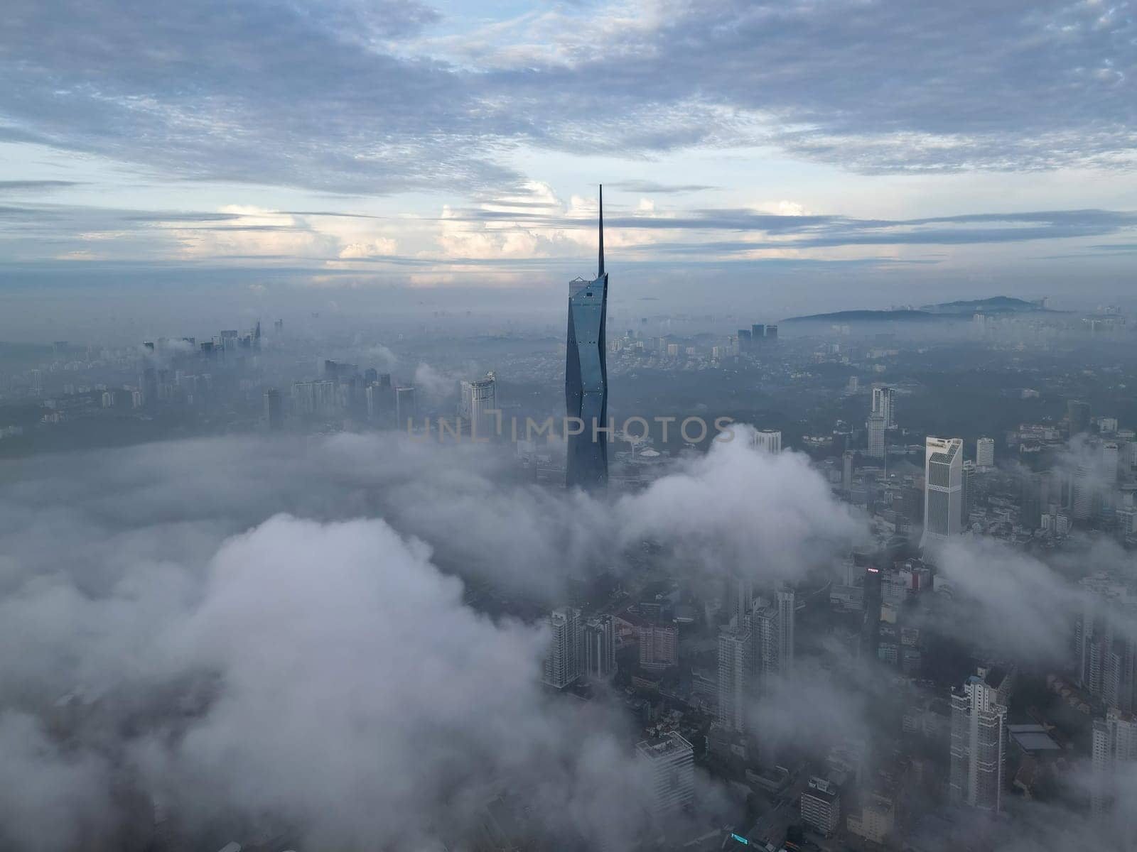 Bukit Bintang, Kuala Lumpur, Malaysia - Nov 13 2022: The aerial view of Merdeka 118 during morning low cloud provides a unique perspective of Kuala Lumpur's skyline.