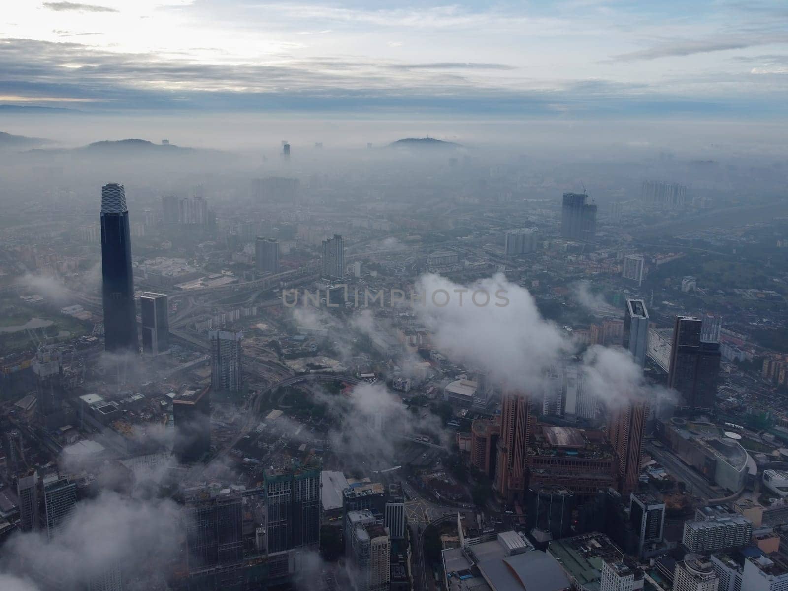 Bukit Bintang, Kuala Lumpur, Malaysia - Nov 13 2022: TRX 106, TRX Signature Tower imposing height pierces through the low-lying clouds, creating a breathtaking sight.