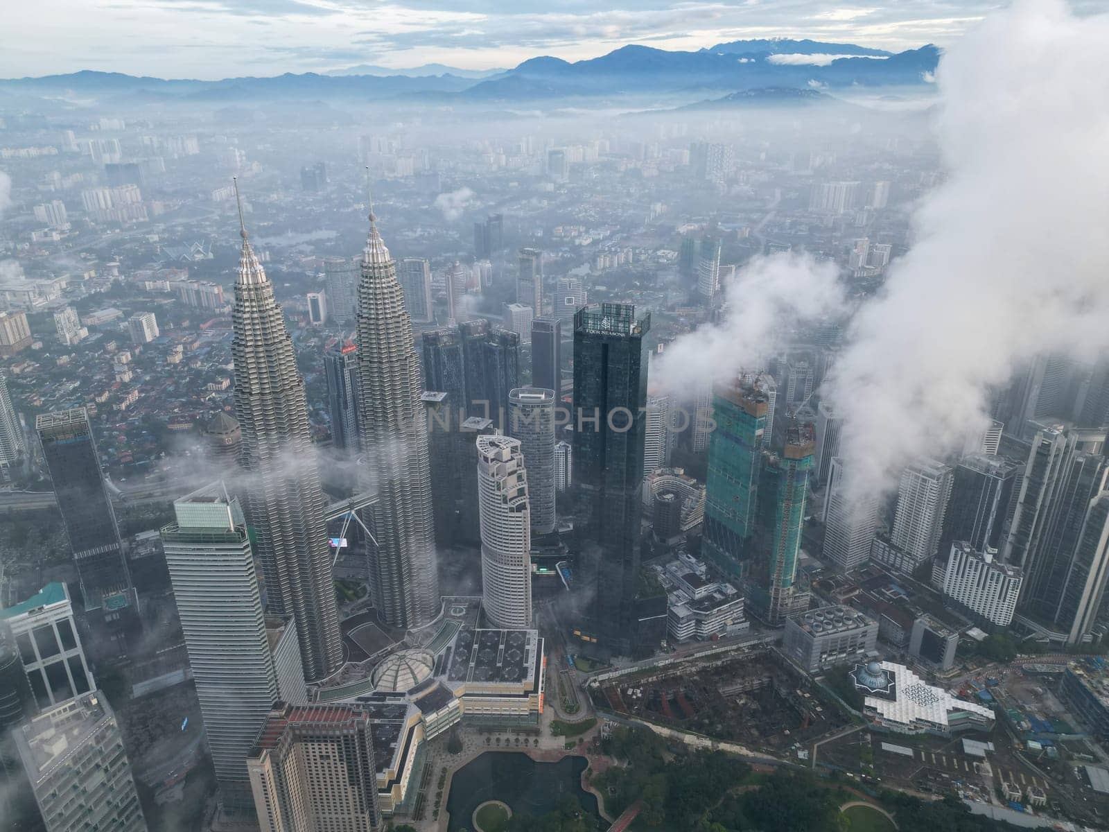 Bukit Bintang, Kuala Lumpur, Malaysia - Nov 13 2022: The KLCC's unique design and futuristic architecture stand out against the cloudy backdrop, adding to its grandeur.