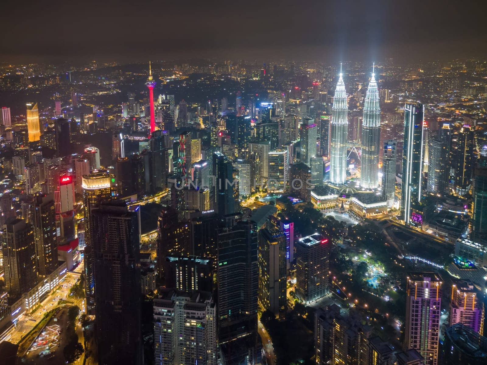 Bukit Bintang, Kuala Lumpur, Malaysia - Nov 28 2022: Aerial view The Petronas Twin Towers stand tall as the centerpiece of the city's skyline in night