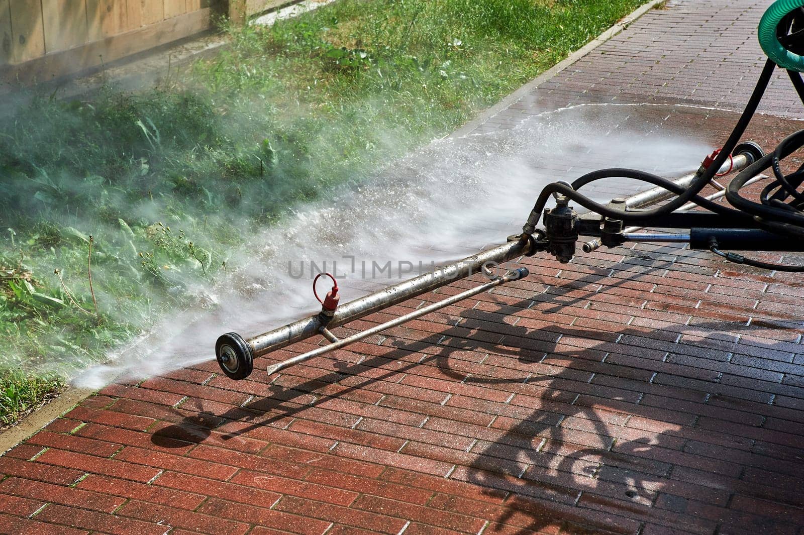 A special machine washes city paths and roads with water. High quality photo