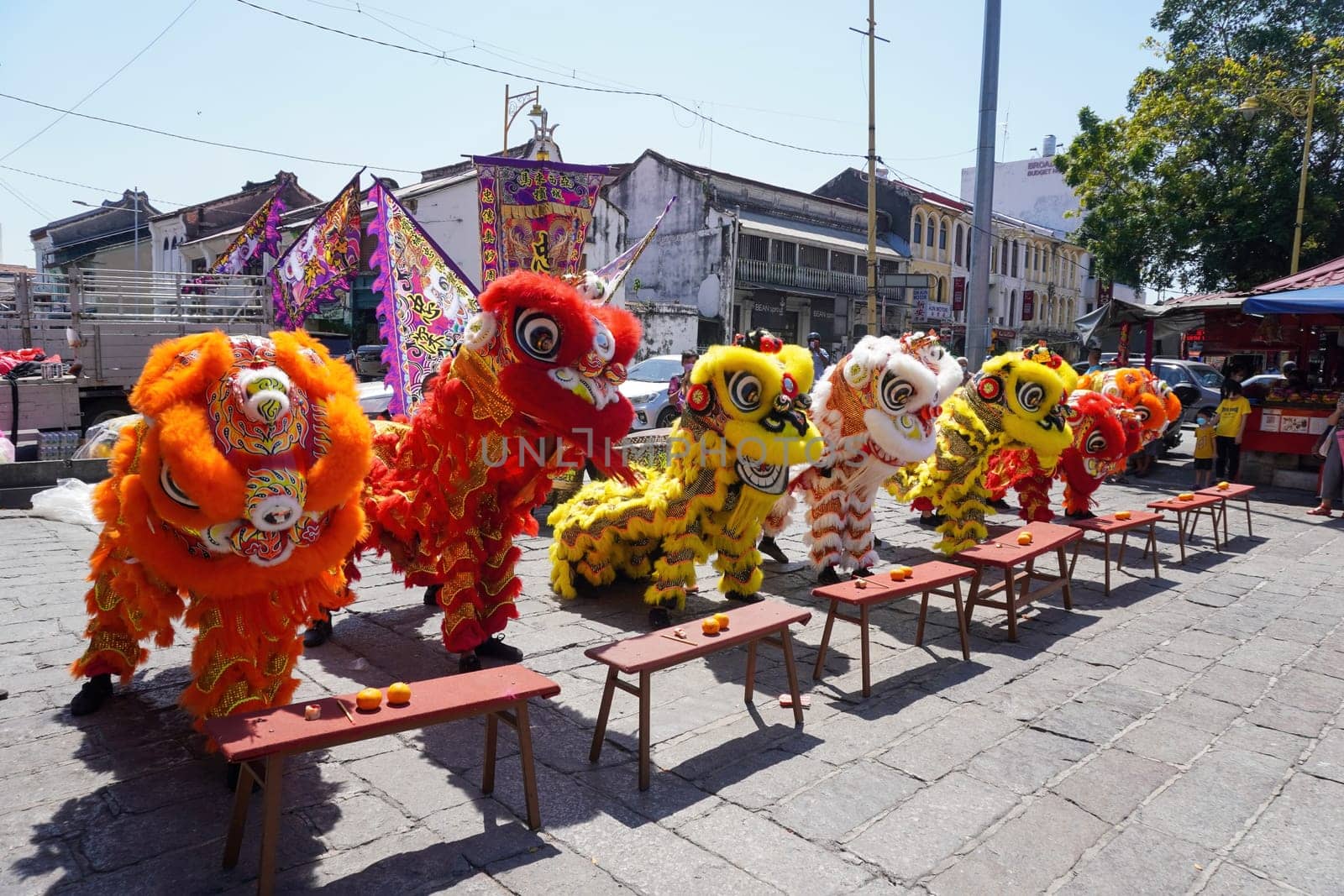 George Town, Penang, Malaysia - Jan 15 2022: Different color Chinese lion dance perform in hot sunny day at consecration ceremony