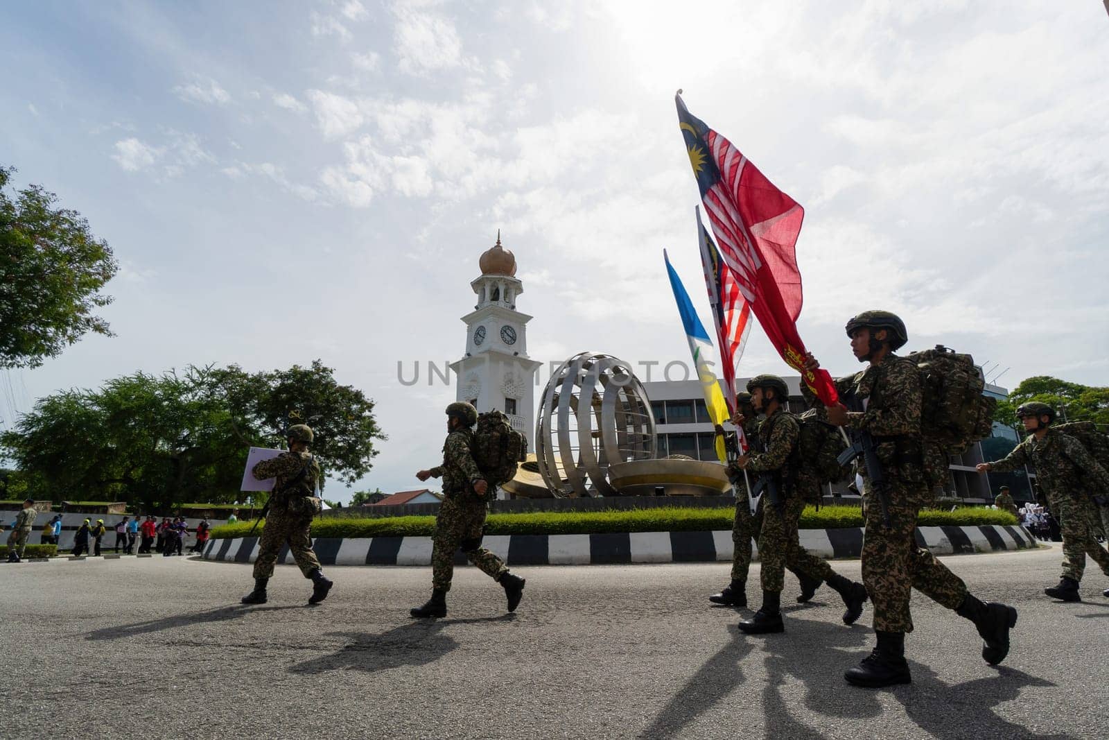 George Town, Penang, Malaysia - Aug 29 2022: Soldier carry Malaysia and Penang flag procession during Merdeka Independence day at Jubilee Clock Tower