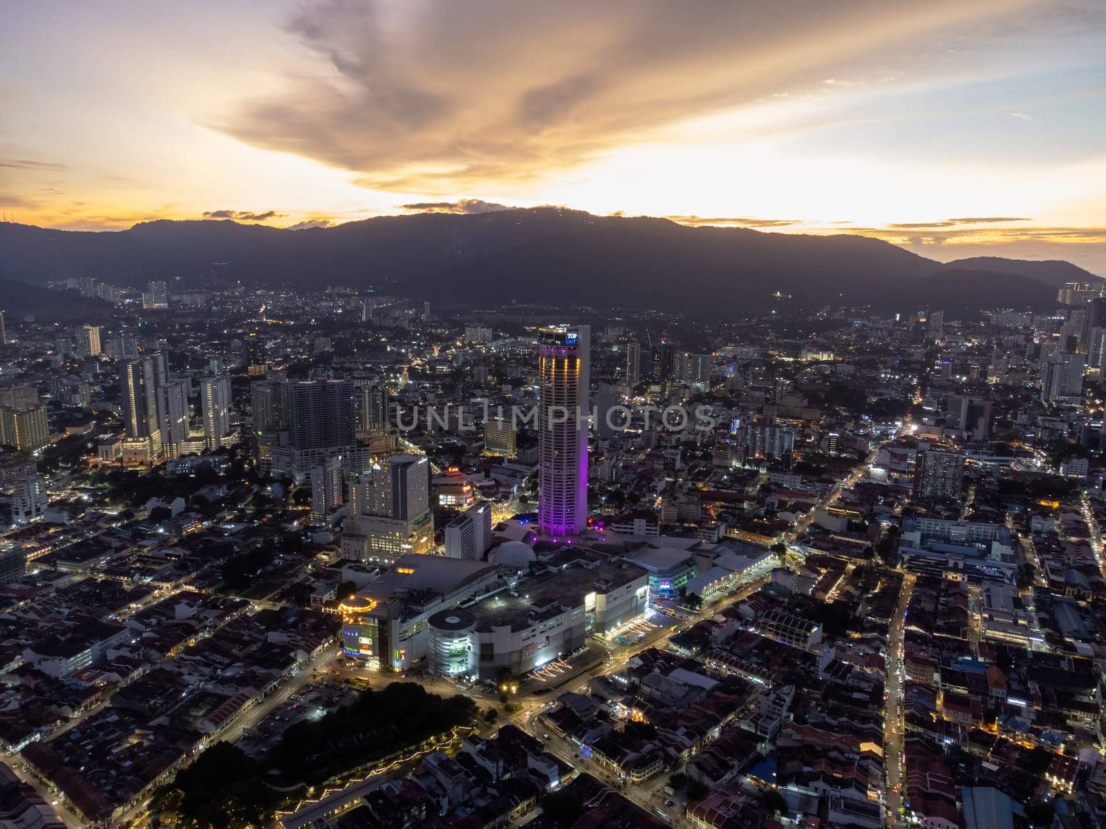 George Town, Penang, Malaysia - Aug 17 2022: Aerial view George Town is light up during dramatic sunset hour
