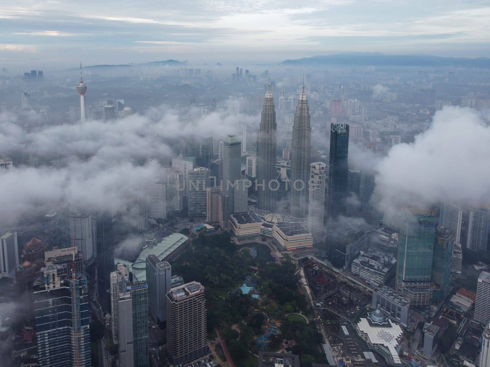 Bukit Bintang, Kuala Lumpur, Malaysia - Nov 13 2022: Aerial view morning low cloud over Bukit Binitang city skyscraper KLCC, KL Tower