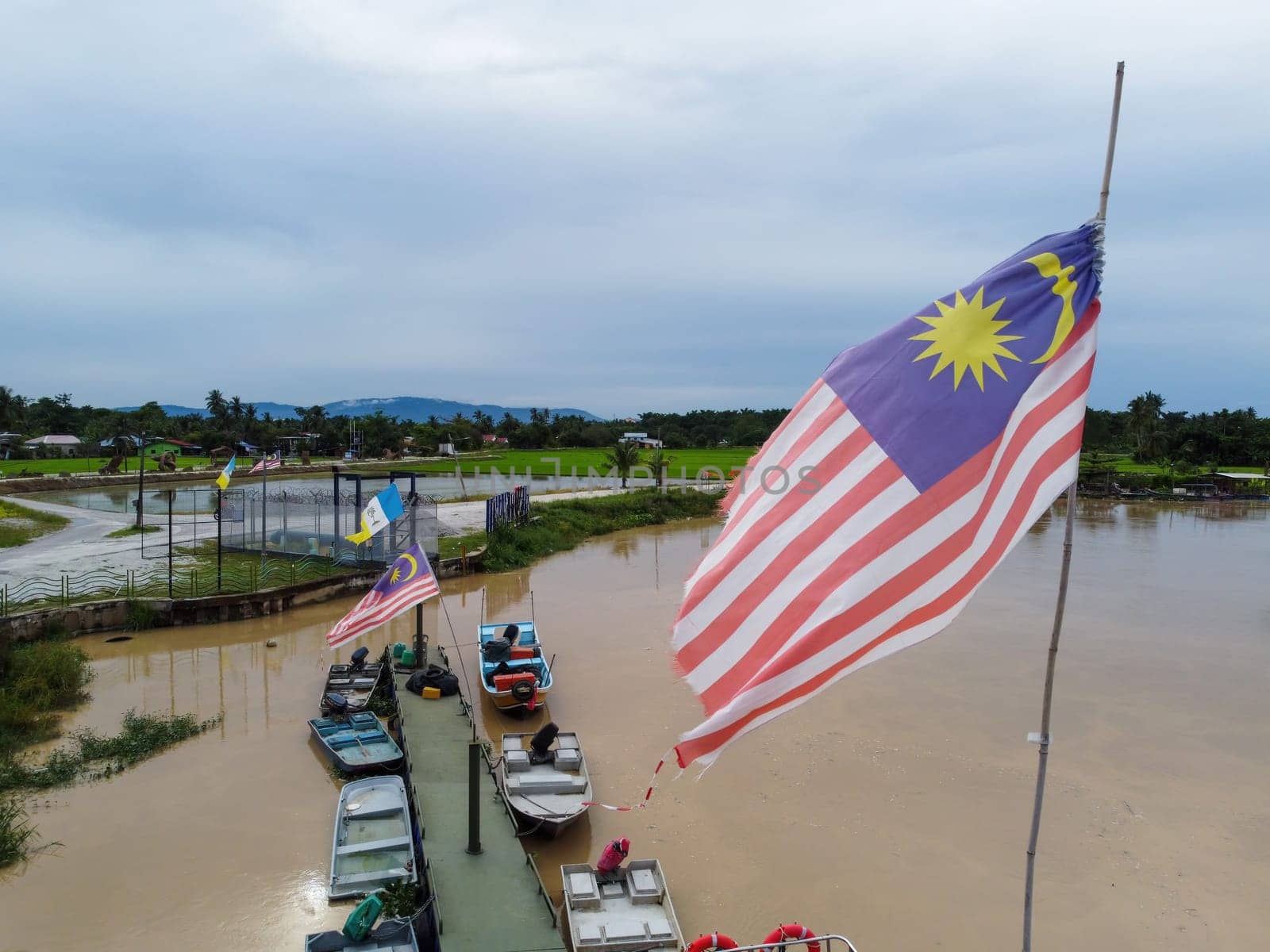 Seberang Perai, Penang, Malaysia - Oct 16 2022: Malaysia flag with background of fishing jetty