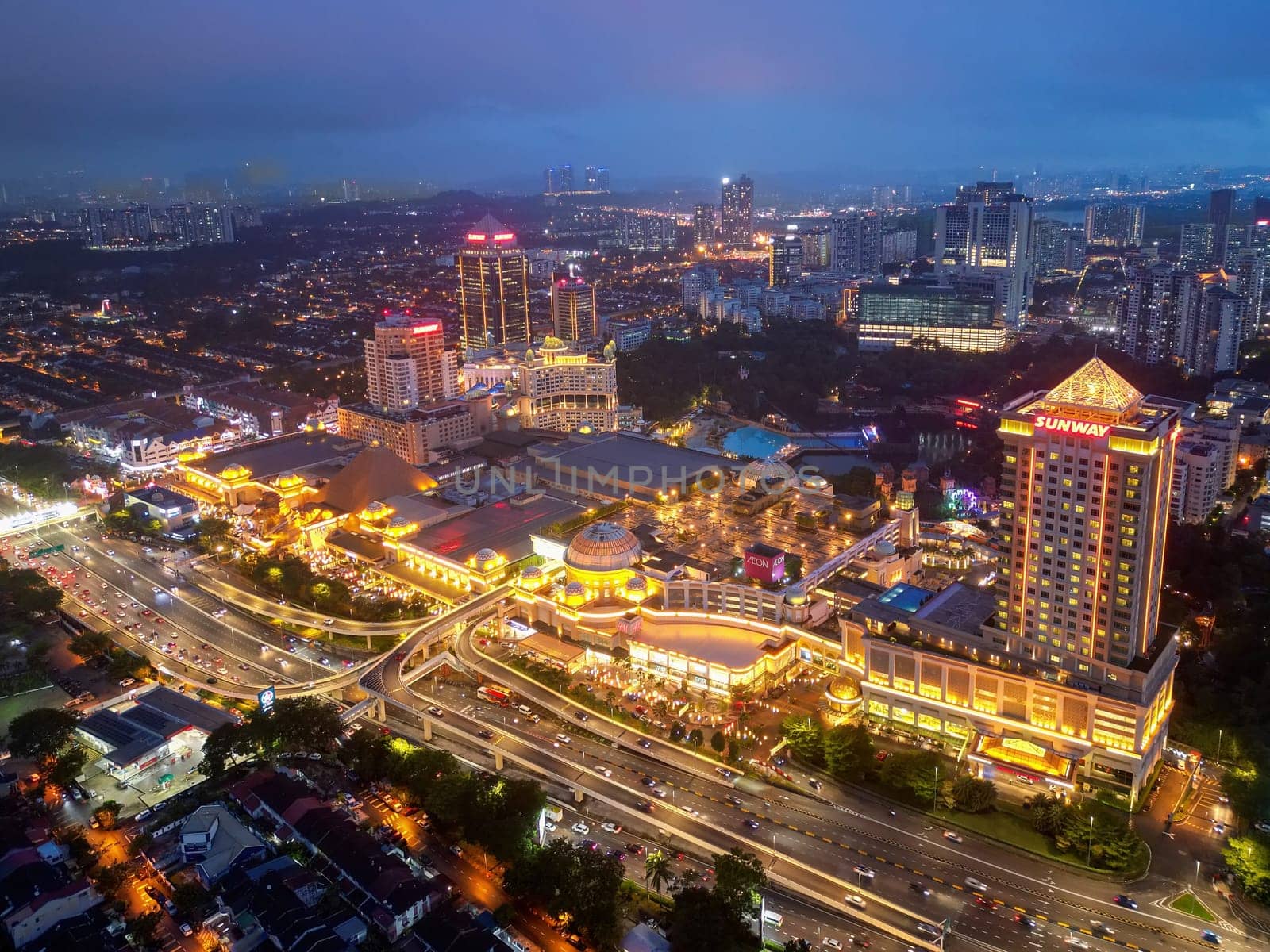 Sunway, Selangor, Malaysia - Nov 10 2022: Drone shot of Sunway Pyramid, Sunway Resort and surrounding city in illuminated