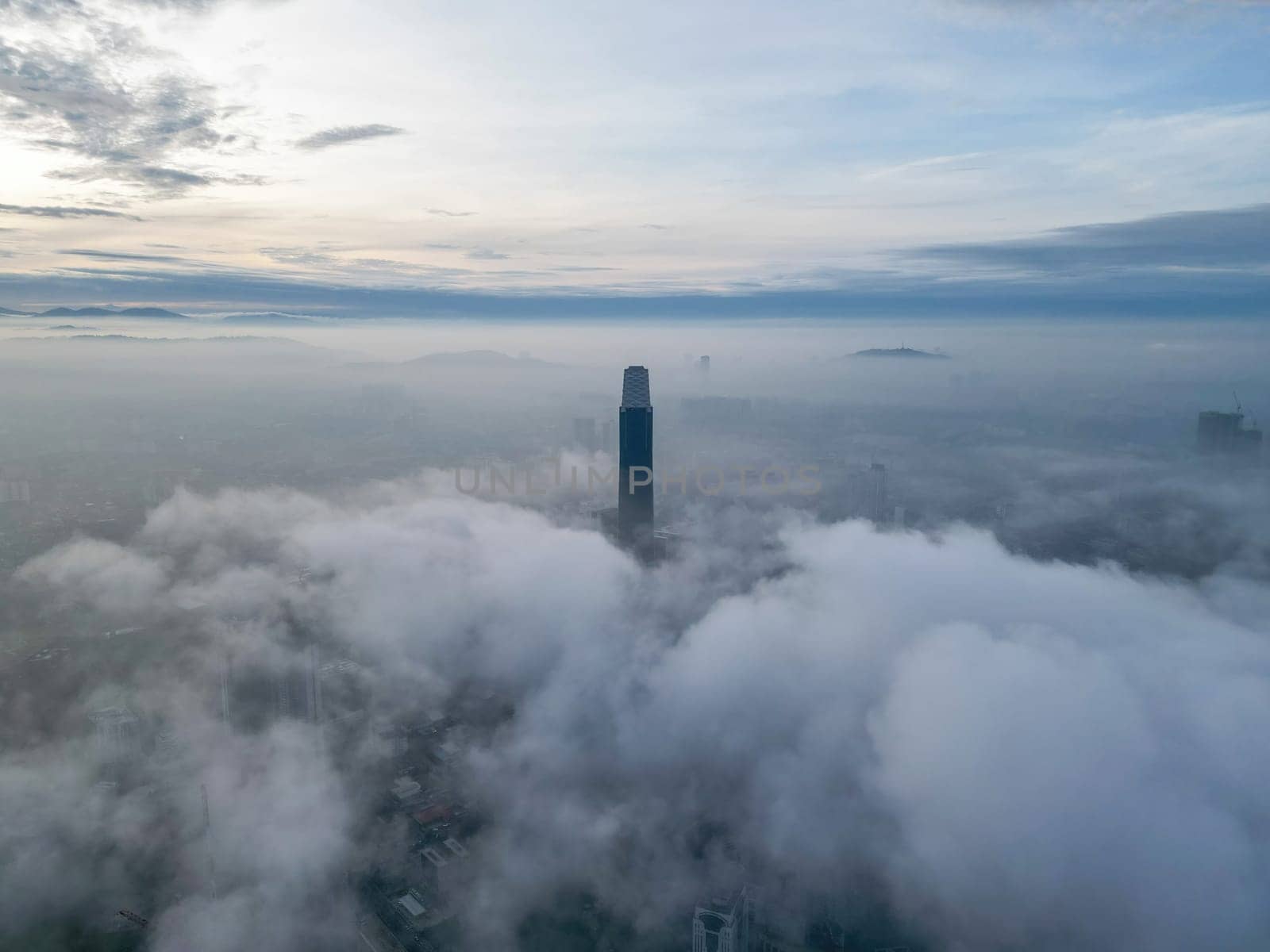 Bukit Bintang, Kuala Lumpur, Malaysia - Nov 13 2022: The low clouds provide a misty veil around the Exchange 106, adding to its mystique.
