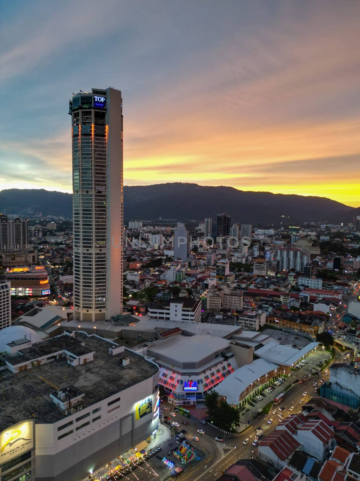 George Town, Penang, Malaysia - Sep 26 2022: Vertical view of Komtar building and Prangin Mall in dramatic sunset hour