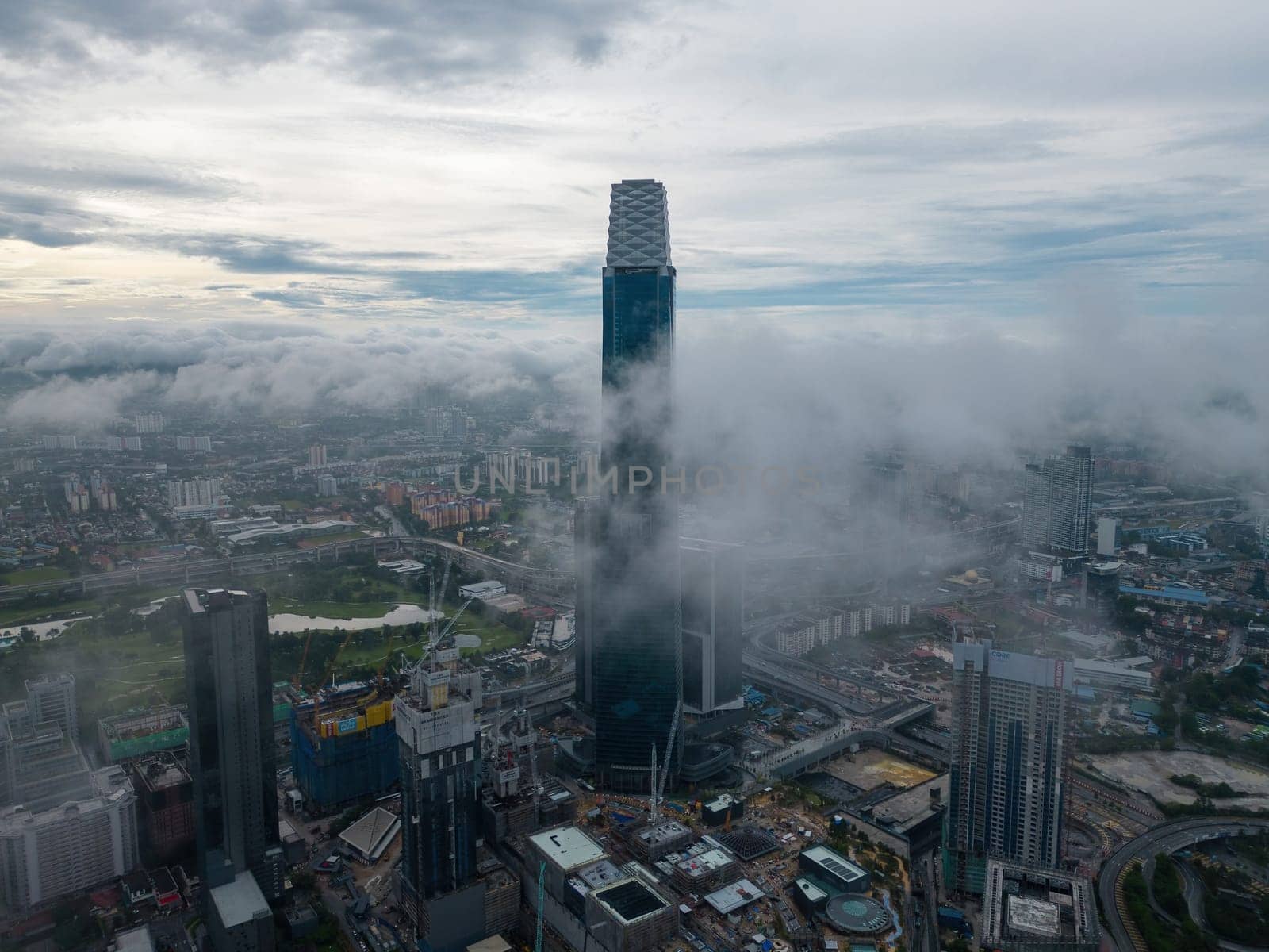 Bukit Bintang, Kuala Lumpur, Malaysia - Dec 03 2022: The surrounding skyscrapers and cityscape look miniature in comparison to the towering Exchange 106.