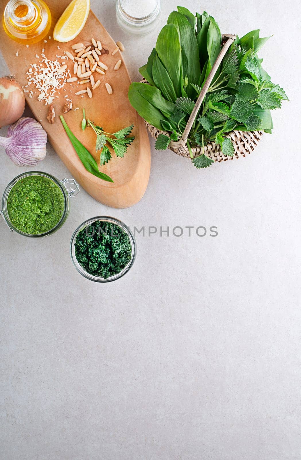 Spring healthy food. Nettle and ramson pesto for healthy meal on grey background
