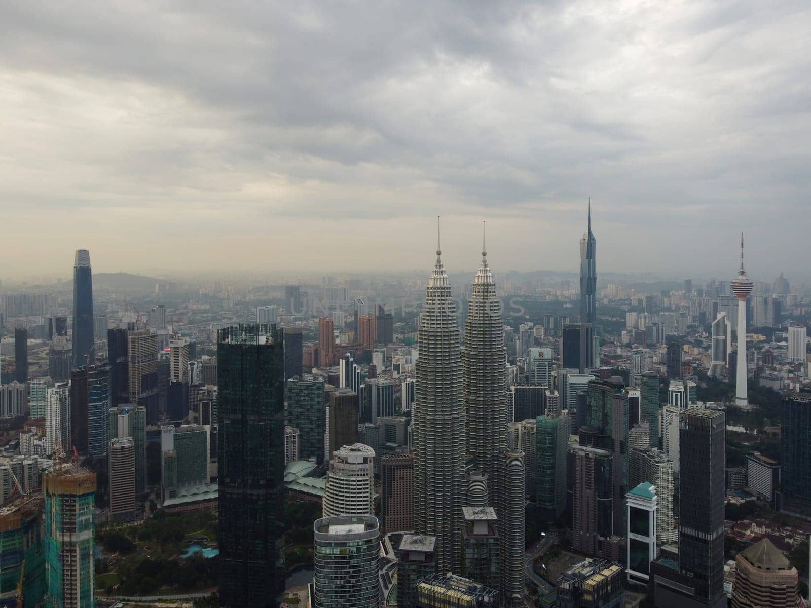 Bukit Bintang, Kuala Lumpur, Malaysia - Dec 25 2022: Aerial shot of Kuala Lumpur's skyline, showcasing the city's iconic Petronas Twin Towers and other towering skyscrapers.