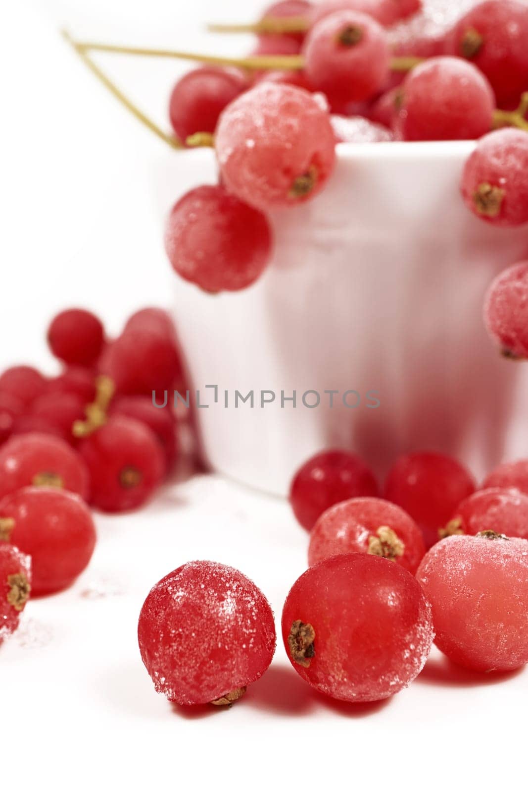 Frozen currants with stems in porcelain bowl