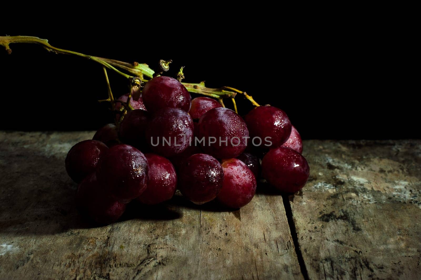 Wine grapes light painting, Abstract fruit still life concept for wine tasting or harvest vineyard on black background