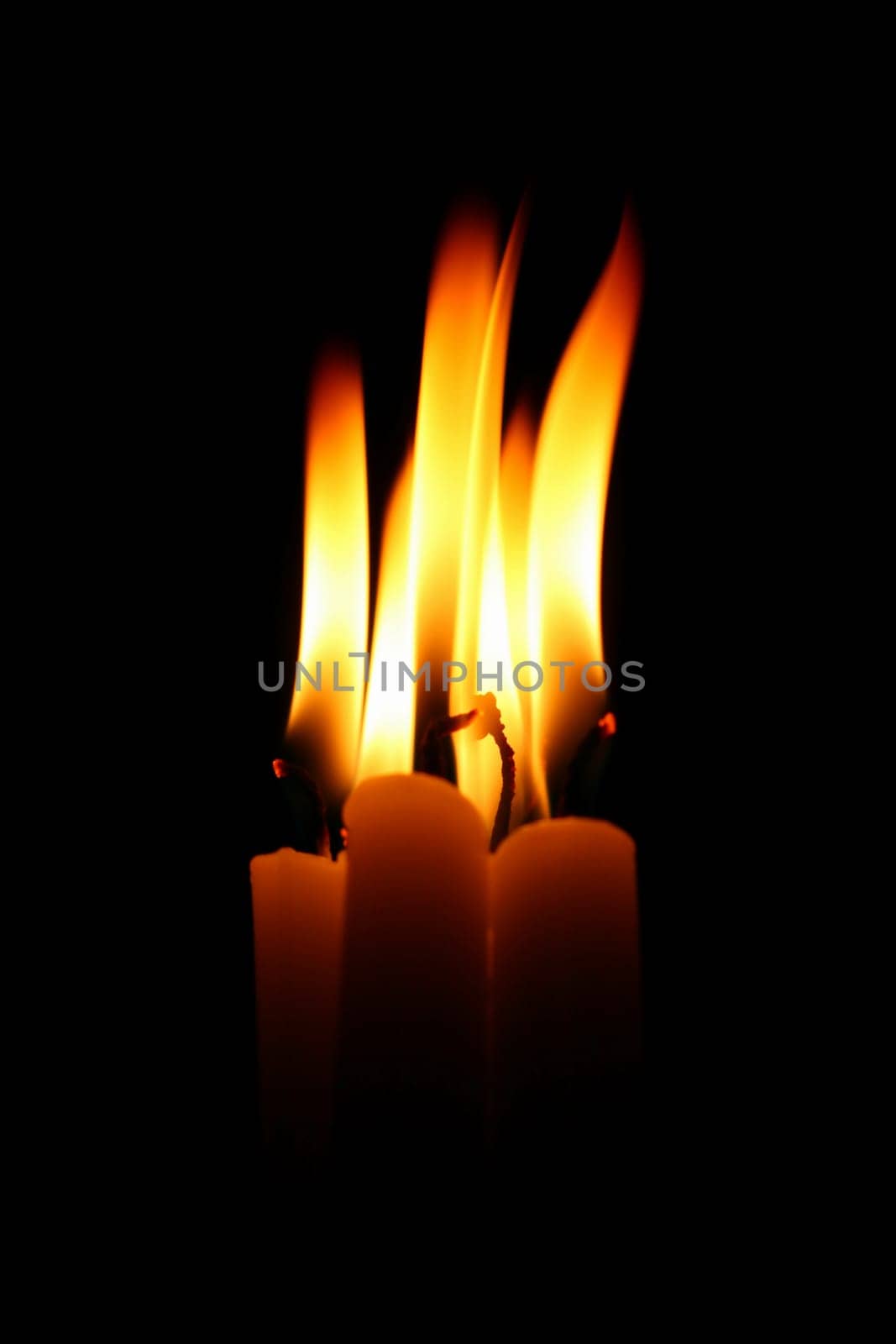 sacred candles in dark on black background