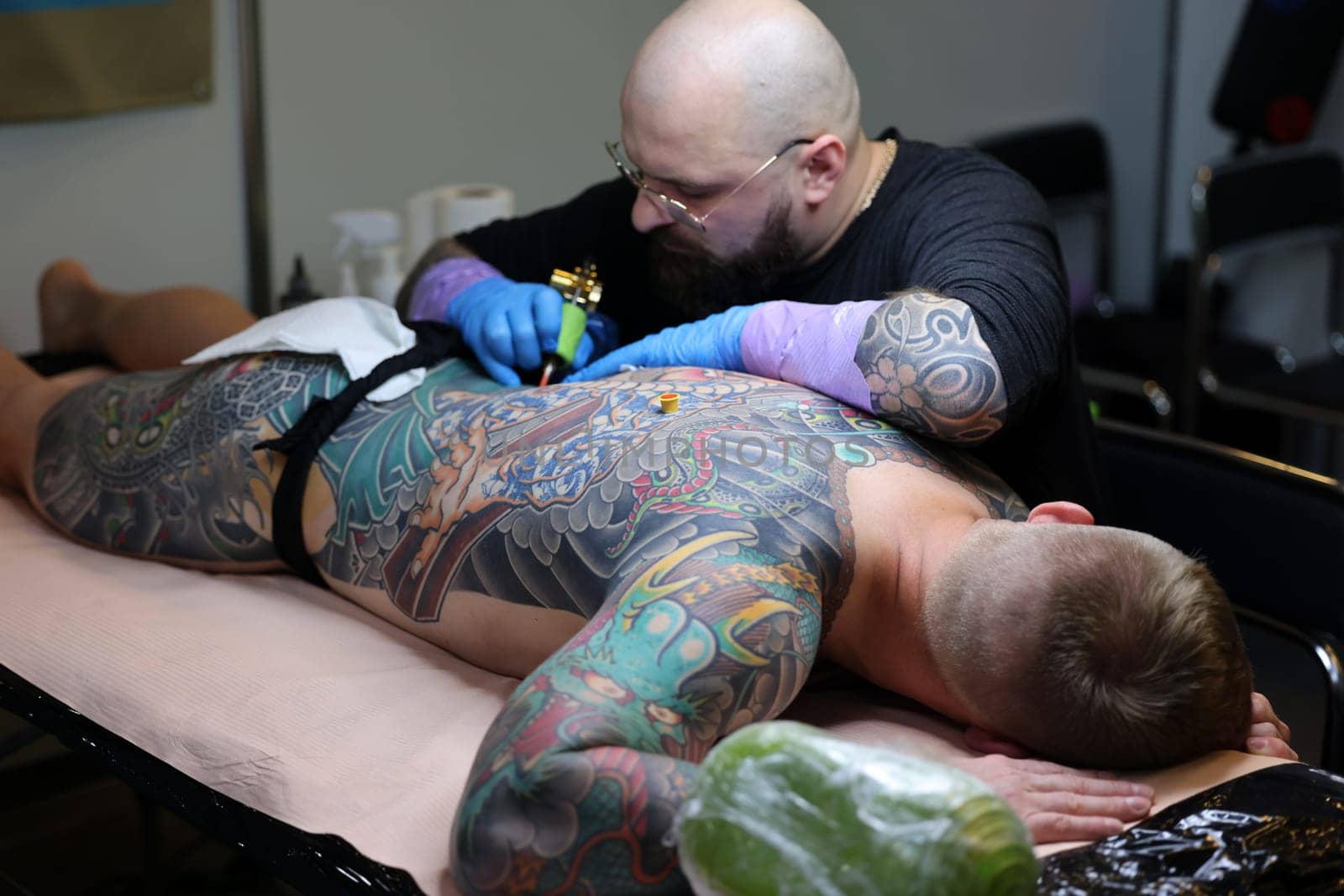 Krakow, Poland -  June 12, 2022: Unidentified  participant at 15th Tattoofest Convention in Cracow. One of the most prestigious tattoo festivals. Tattoo artist at work.