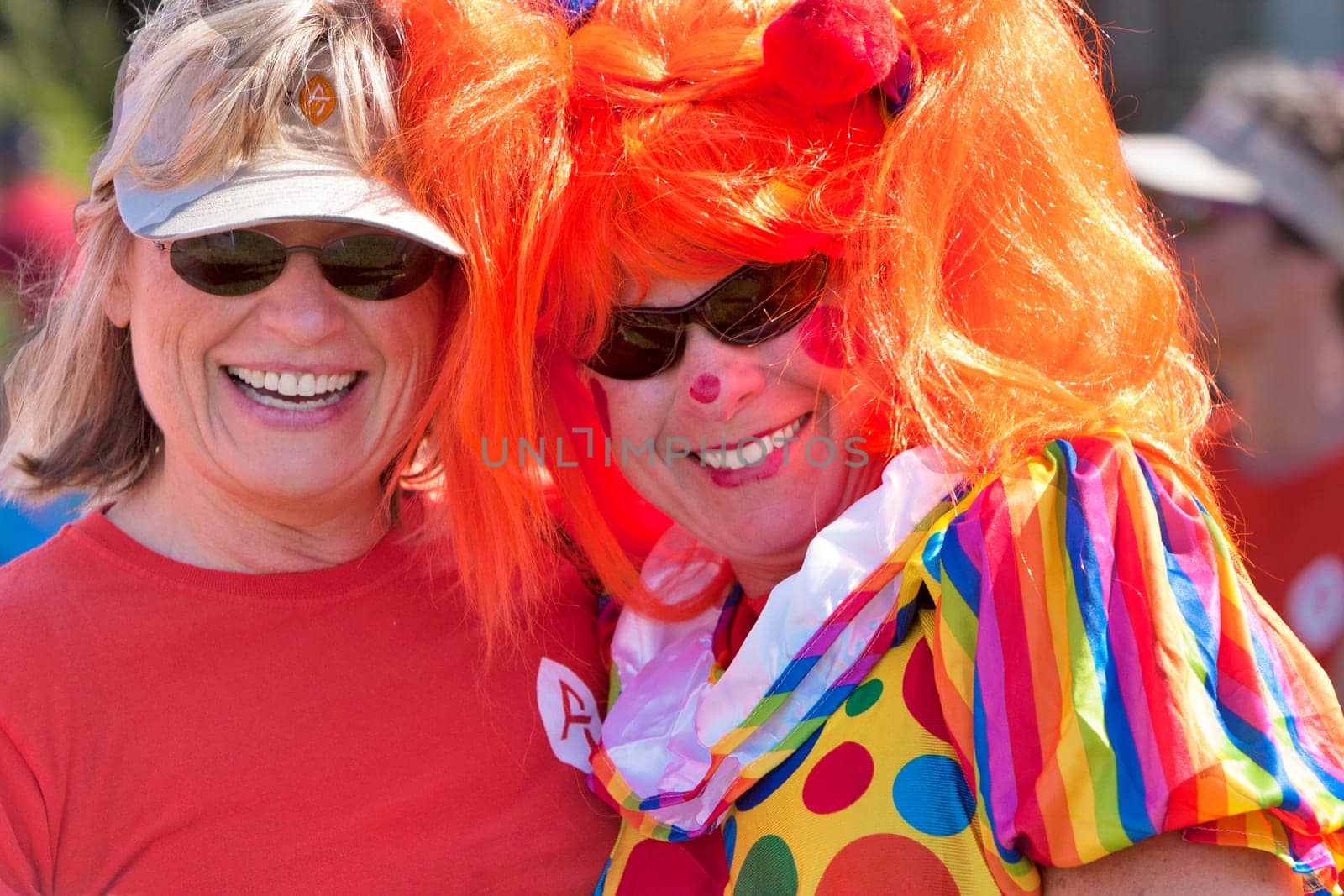 Two women dress up for the Dragon Boat races held world wide to raise money for breast cancer survivors.  Burlington, Vermont.
