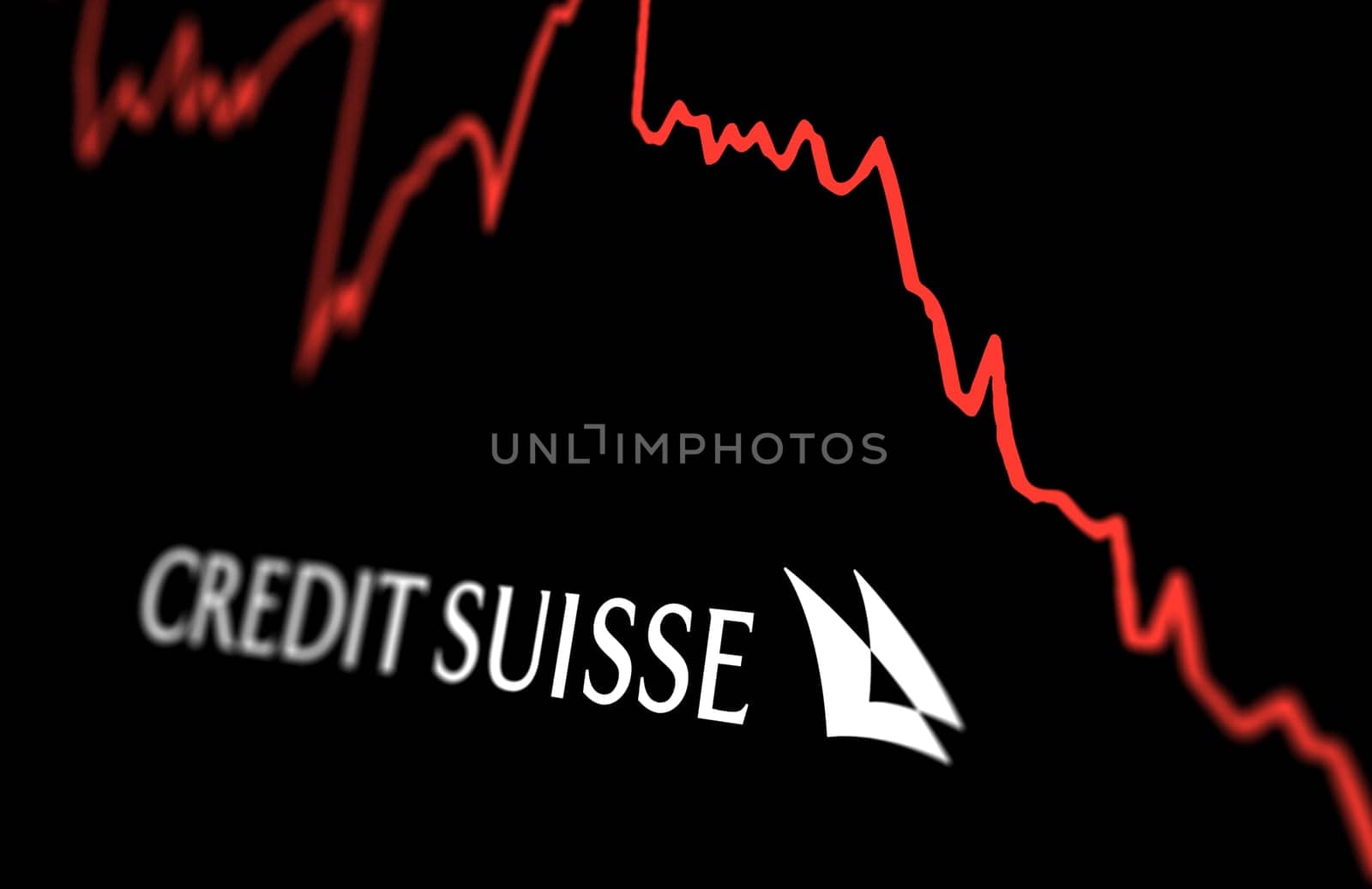 New York, US, March 2023: White Credit Suisse logo on a stock market performance chart trends. In March 2023, Credit Suisse experienced a sharp drop in its stock price. Illustrative editorial
