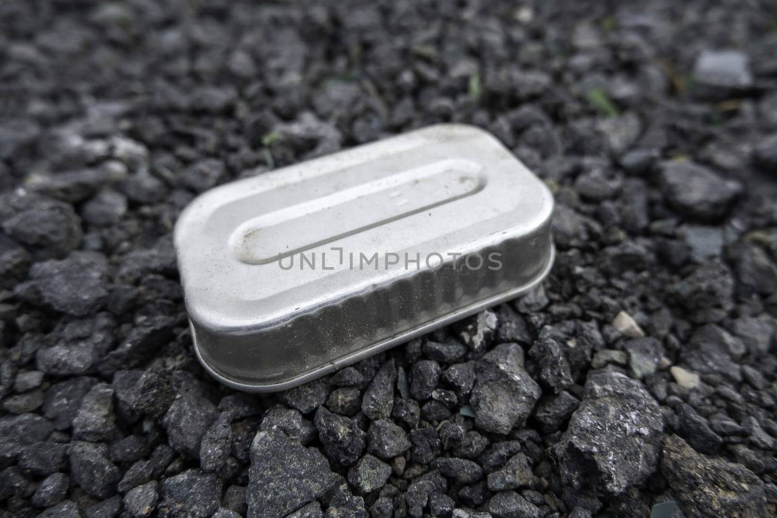 Detail of metal can thrown away in nature, destruction of the environment