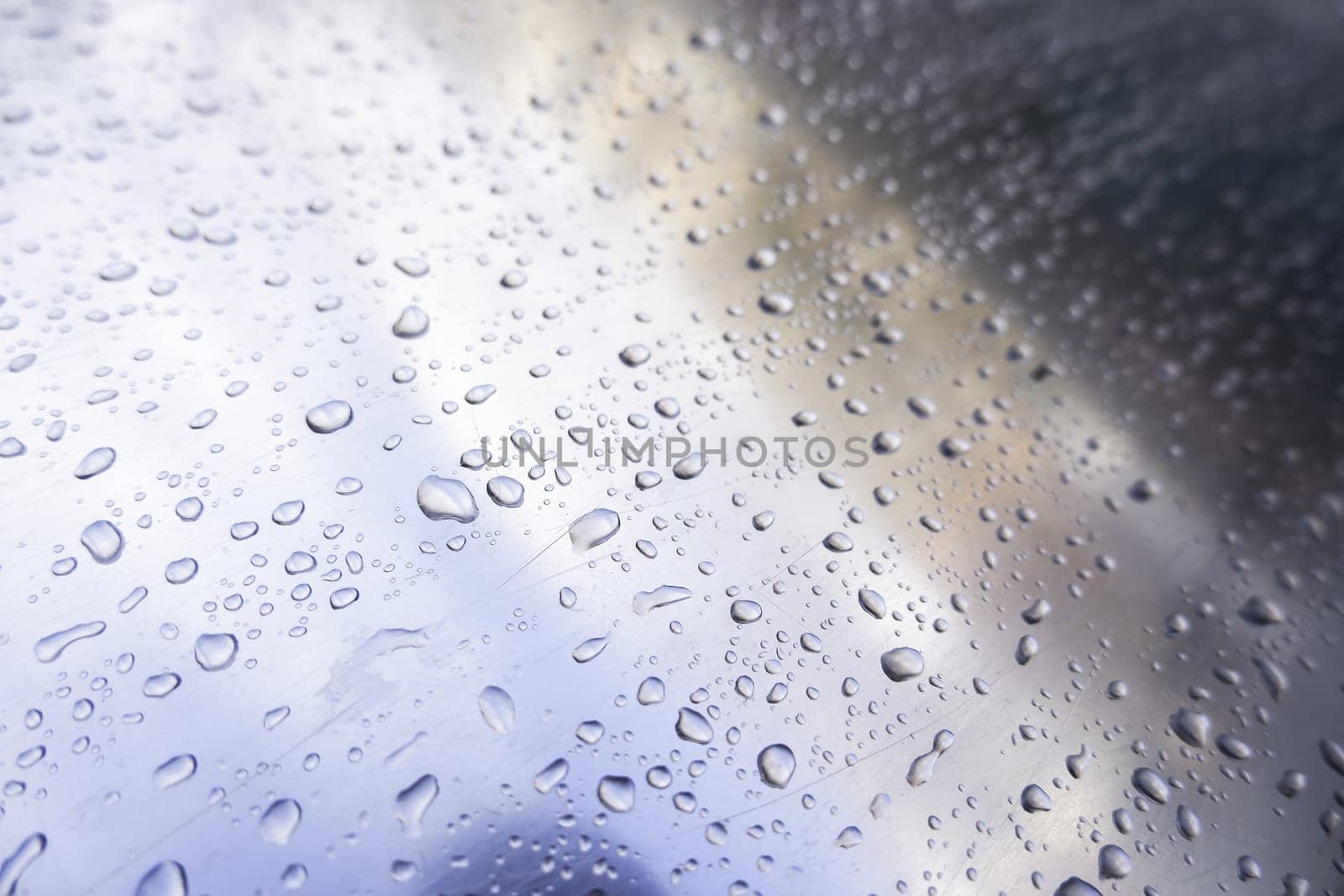 Detail of stainless steel surface wet from the rain