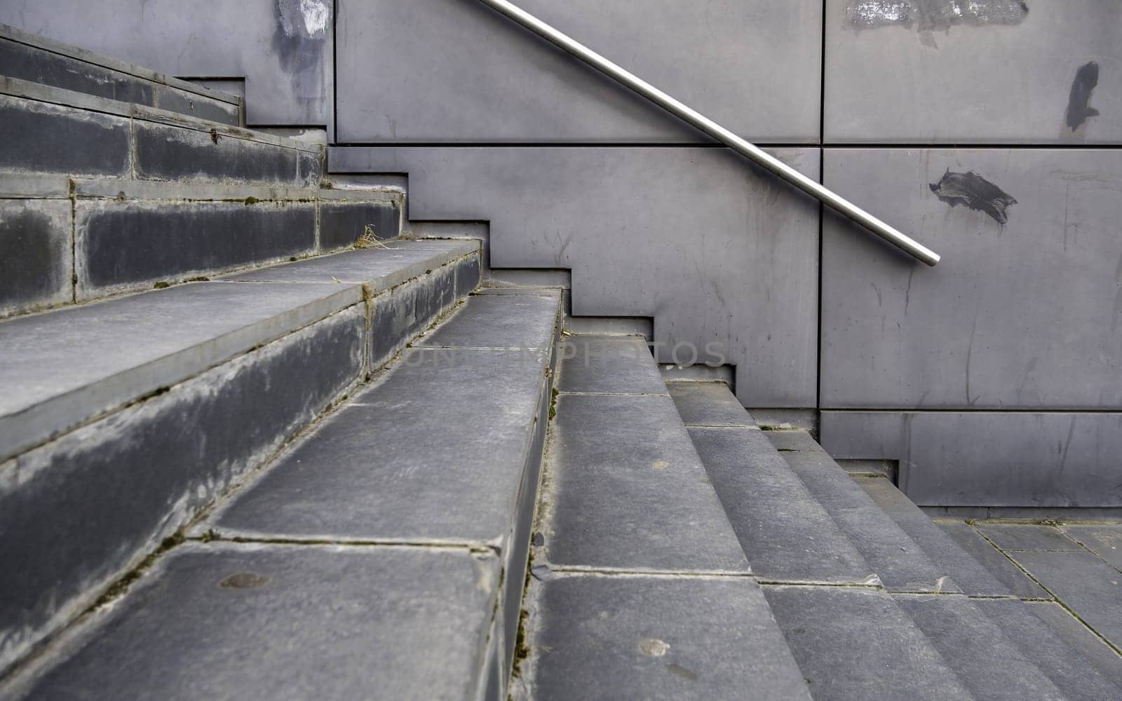 Detail of modern exterior staircase in the city, decorated with natural stone