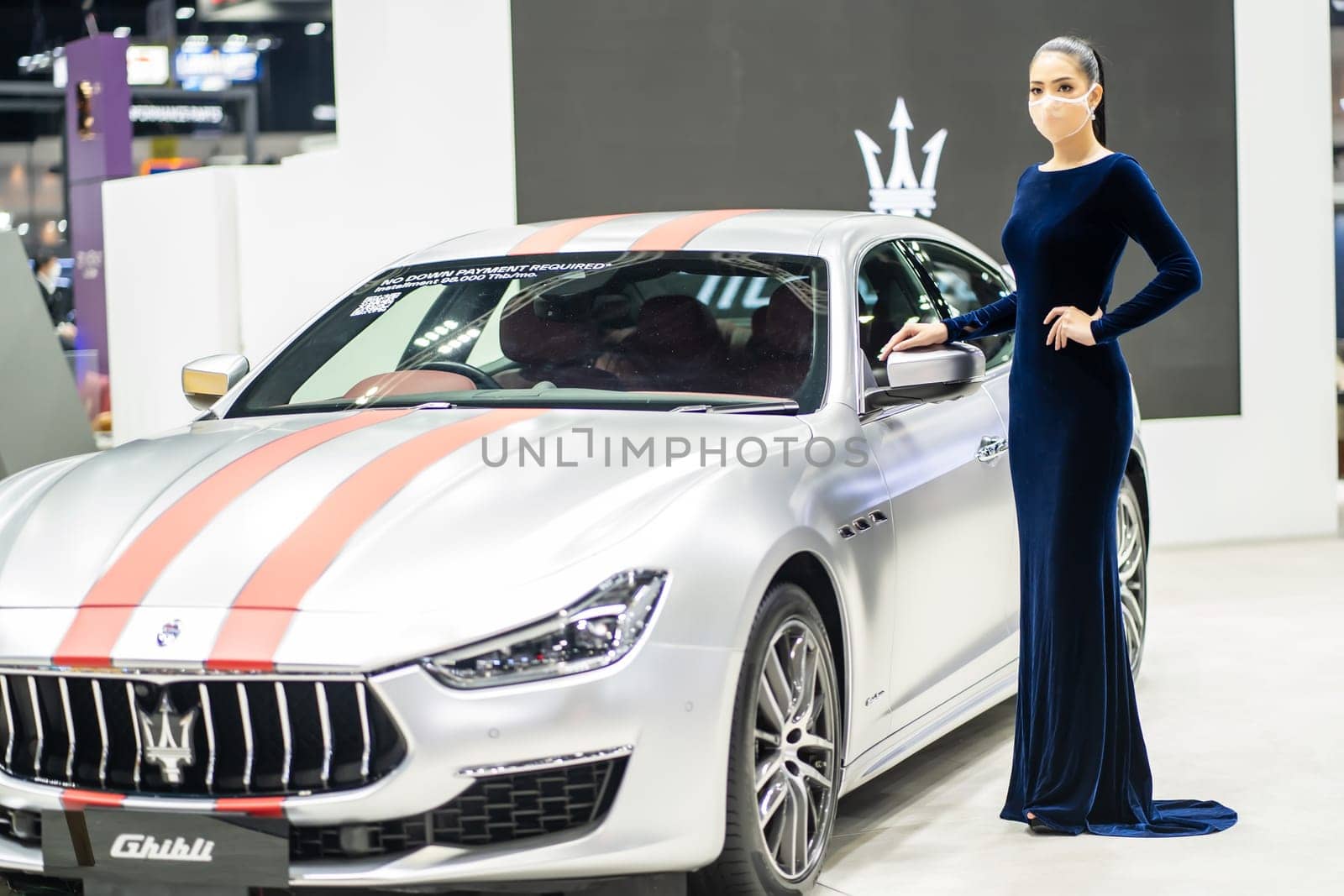 Nonthaburi, Thailand - DEC 4, 2021 - Unidentified model poses with a car at The 38th Motor Expo Thailand 2021 at IMPACT Arena, Muang Thong Thani, Nonthaburi, Thailand.