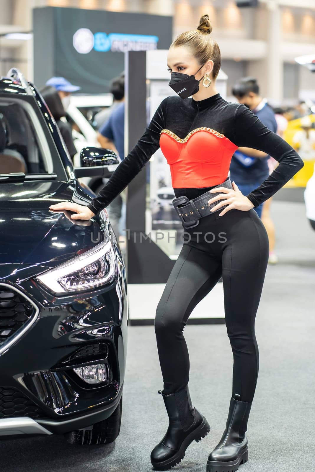 Nonthaburi, Thailand - DEC 4, 2021 - Unidentified model poses with a car at The 38th Motor Expo Thailand 2021 at IMPACT Arena, Muang Thong Thani, Nonthaburi, Thailand.