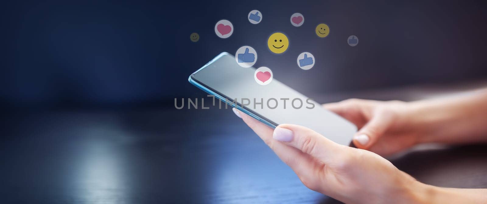 Woman's hands holding mobile phone on the black background. Concept of the social media and internet.
