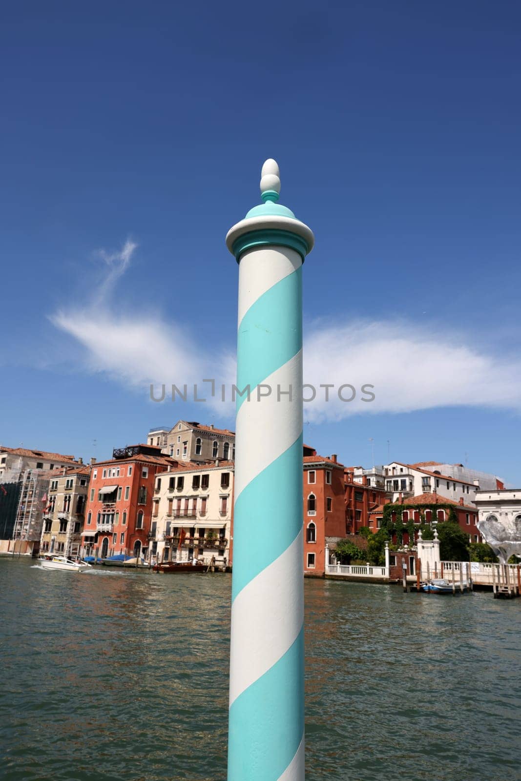 Venice, Italy - September 5, 2022: Wooden mooring pole at Canal Grande in Venice. Italy