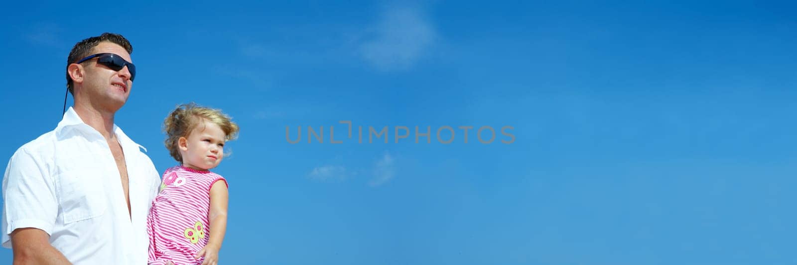 view of young family hanging out in summer environment. Banner, lots of copyspace.