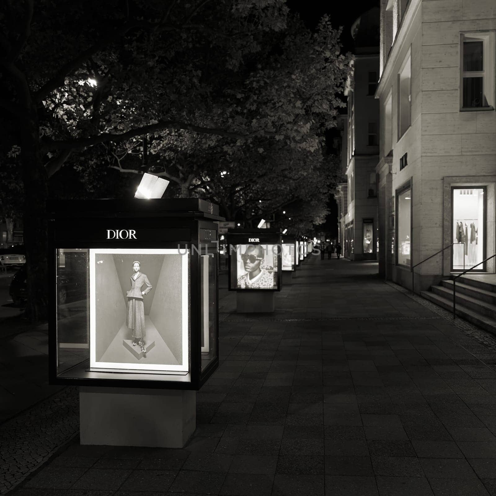 illuminated outdoor advertisement of french designer Dior on Kurfuerstendamm in Berlin by night