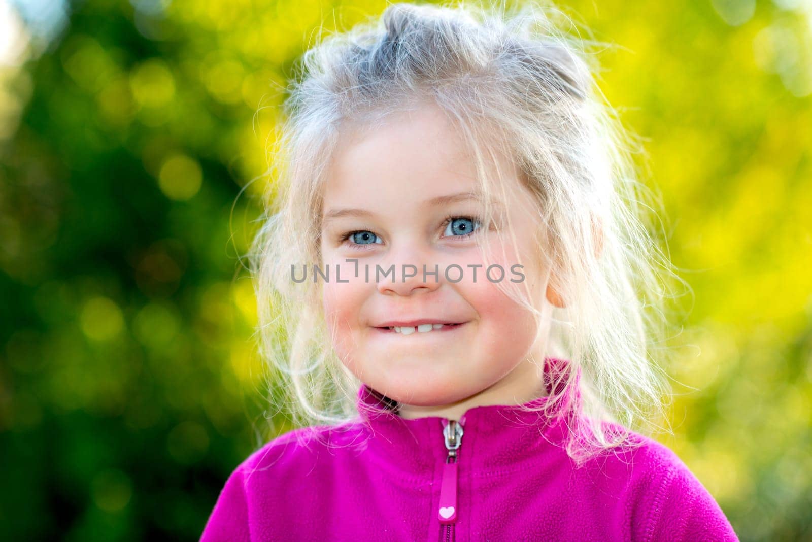little nice girl in front of nature background is happy